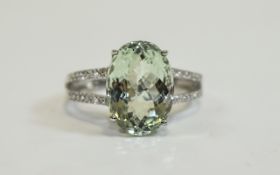 Green Amethyst Solitaire Ring, a 6ct oval cut green amethyst set in a platinum vermeil and silver,