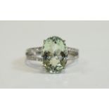 Green Amethyst Solitaire Ring, a 6ct oval cut green amethyst set in a platinum vermeil and silver,