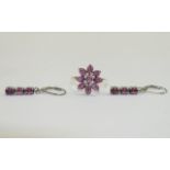 Rhodolite Garnet Cluster Ring and Drop Earrings, the ring comprising nine oval cut, plum colour