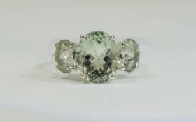 Green Amethyst Three Stone Ring, a 5ct oval cut green amethyst flanked by two further green