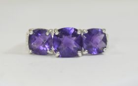 Amethyst Trilogy Ring, the central amethyst, cushion cut, flanked by two similar, slightly smaller