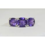 Amethyst Trilogy Ring, the central amethyst, cushion cut, flanked by two similar, slightly smaller