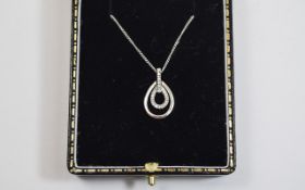 9ct White Gold Diamond Pendant & Chain. Pear shaped outer ring with inner diamond ring drop collar.