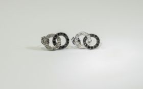 Pair Of Ladies 9ct Gold Stud Earrings Interlocking rings set with black and white diamonds.