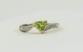 9ct Gold Ring set with a central pear cut green olivine stone,