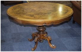 Large Circular Walnut Inlay Table Raised on a turned column with carved acanthus style legs.