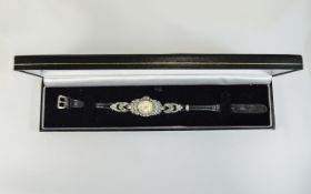 A Ladies Majorex Marcasite Wristwatch, Working In a Black Fitted Case, on a Black Leather Strap.