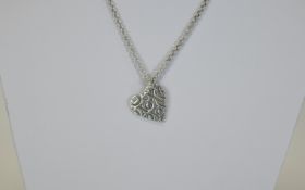 Tiffany style heart shaped pendant suspended on a Italian silver chain. Stamped .