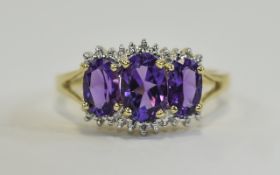 Diamond and Amethyst Cluster Ring 9ct ring with 3 central faceted oval Amethysts in raised setting