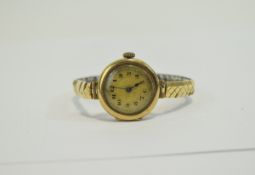 Ladies 9ct Gold Circular Cased Wrist Watch with Champagne Dial and Attached Gold Plated Bracelet.