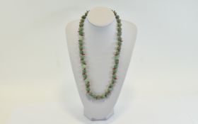 Jadeite Stone Bead Necklace, each set between a coral branch.