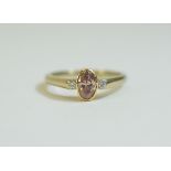 18ct Gold 3 Stone Ring Set with An Oval Brilliant Cut Natural Pink Diamond, Flanked by Two Round