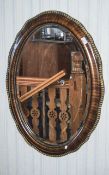 Large Oval Mahogany Framed Mirror Features oval bevelled glass in mahogany and brass detailed