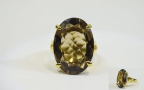 Large Smoky Quartz Solitaire Ring, a 22ct oval cut smoky quartz of good,