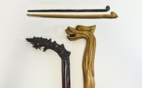 Walking Canes 2 in total, hand carved in oriental style with carved dragon head handles.