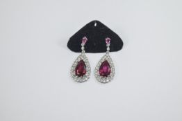 Pair of Faux Ruby and Diamond Drop Earrings, solitaire pear cut Burmese colour faux rubies, framed