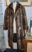 Mink Coat Ladies mid-length mink coat with shawl collar, deep cuffs and internal tie closure.