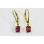 Ruby Pair of Drop Earrings, two solitaire, oval cut, rich red rubies, totalling 2.