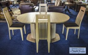 A Contemporary Blonde Ercol Extending Dining Table And Chairs. Designed by Brigitte Forestier.