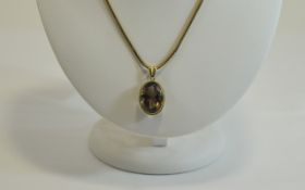 9ct Gold Set Large Faceted - Oval Shaped Amethyst Pendant with Attached 9ct Gold Chain.