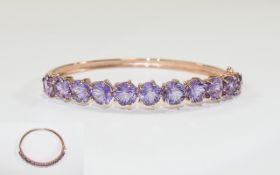 Rose de France Amethyst Bangle, a row of eleven flower cut amethysts totalling 15cts,