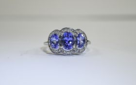 Tanzanite and Diamond Trilogy Ring, three oval cut tanzanites, of excellent colour,