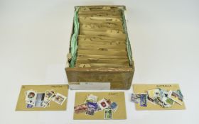 Shoebox size container full of all world stamps sorted into countries in envelopes.