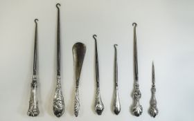 A Good Collection of Victorian and Edwardian Silver Ornate and Embossed Handle Button Hooks ( 7 )