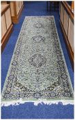 Long Wool Hallway Runner Patterned rug in dark blue, taupe, cream and green on Eau De Nil ground.
