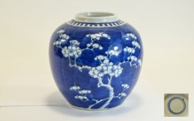 Chinese 19th Century Kangxi Globular Shaped Blue and White Jar with Prunus Decoration on Blue