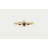 18ct Gold Hinged Bangle set with three rubies, surrounded by round brilliant cut diamonds.