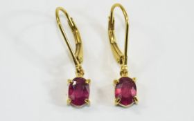 Ruby Pair of Drop Earrings, two solitaire, oval cut, rich red rubies, totalling 2.25cts, set in 14ct