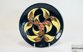 Moorcroft Modern Tube lined Small Circular Plate - Hollies and Berries Design on Black Ground.