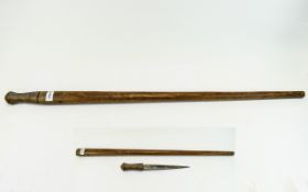 African Sword/Dagger Stick Possibly early 20th Century, housed in traditional wooden casing.