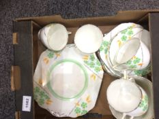 Part Teaset green and orange floral decoration on white ground.