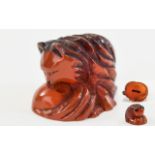 Carved Amber Coloured Netsuke In The Form Of A Stylised Cat, Rubbed Condition,