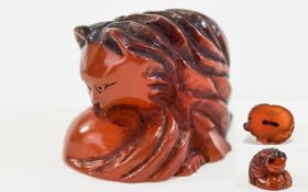 Carved Amber Coloured Netsuke In The Form Of A Stylised Cat, Rubbed Condition,