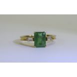 18ct Gold Set Single Stone Emerald Ring with Diamond Shoulders.