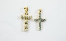 Two Gold Stone Set Crosses. Attractive cross pendants, the larger set with 6 clear faceted stones.