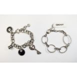 Two DKNY Designer Bracelets. Charm bracelet with various designer branded and crystal charms.