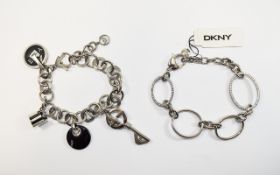 Two DKNY Designer Bracelets. Charm bracelet with various designer branded and crystal charms.