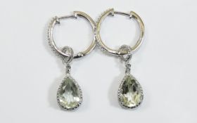 Green Amethyst Hoop and Pendant Earrings, each earring comprising a 2.75ct pear cut green amethyst