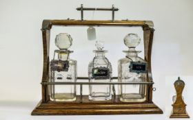 Victorian Oak Tantalus with 3 Cut Glass Decanters and Silver Plated Mounts. Height 12.