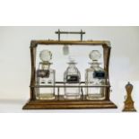 Victorian Oak Tantalus with 3 Cut Glass Decanters and Silver Plated Mounts. Height 12.