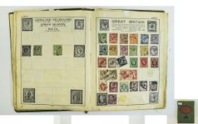 An old battered A5 Victory stamp album filled with many old stamps.