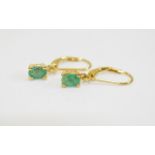 Pair of Emerald Drop Earrings, oval cut solitaire emeralds, totalling 1ct,