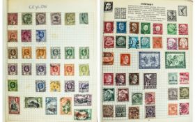 Red spring back stamp album. Well filled, especially Ceylon and Germany.