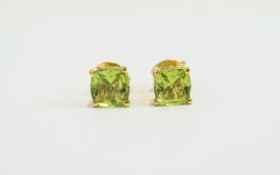 Peridot Pair of Stud Earrings, cushion cut solitaires totalling 2cts,