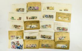 Shoebox full of stamps from around the world sorted into packets of individual countries.