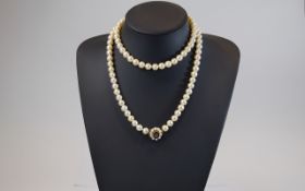 A Fine Single Row Uniform Cultured Pearl Necklace on Garnet,